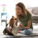 Young Woman Playing With Her Dog At Home